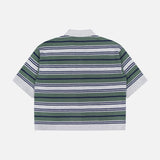 The TWP Short Sleeve Polo with Stripes features horizontal green, navy, white, and gray stripes and is displayed from the back against a plain white background—making it a versatile workwear option for women.