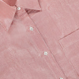A close-up of the TWP Something Borrowed Striped Shirt, featuring red and white stripes, a collar, white buttons, and an inner label—an ideal women's workwear choice.