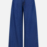 The Song Sung Blue Jean in Dark Stone by TWP features a high waist, wide-leg silhouette, front button and zipper closure, and two front pockets. Displayed on a plain white background, these women’s relaxed jeans bring effortless style and comfort to any casual occasion.