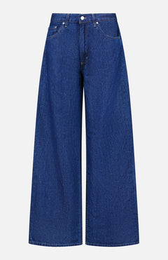 The Song Sung Blue Jean in Dark Stone by TWP features a high waist, wide-leg silhouette, front button and zipper closure, and two front pockets. Displayed on a plain white background, these women’s relaxed jeans bring effortless style and comfort to any casual occasion.