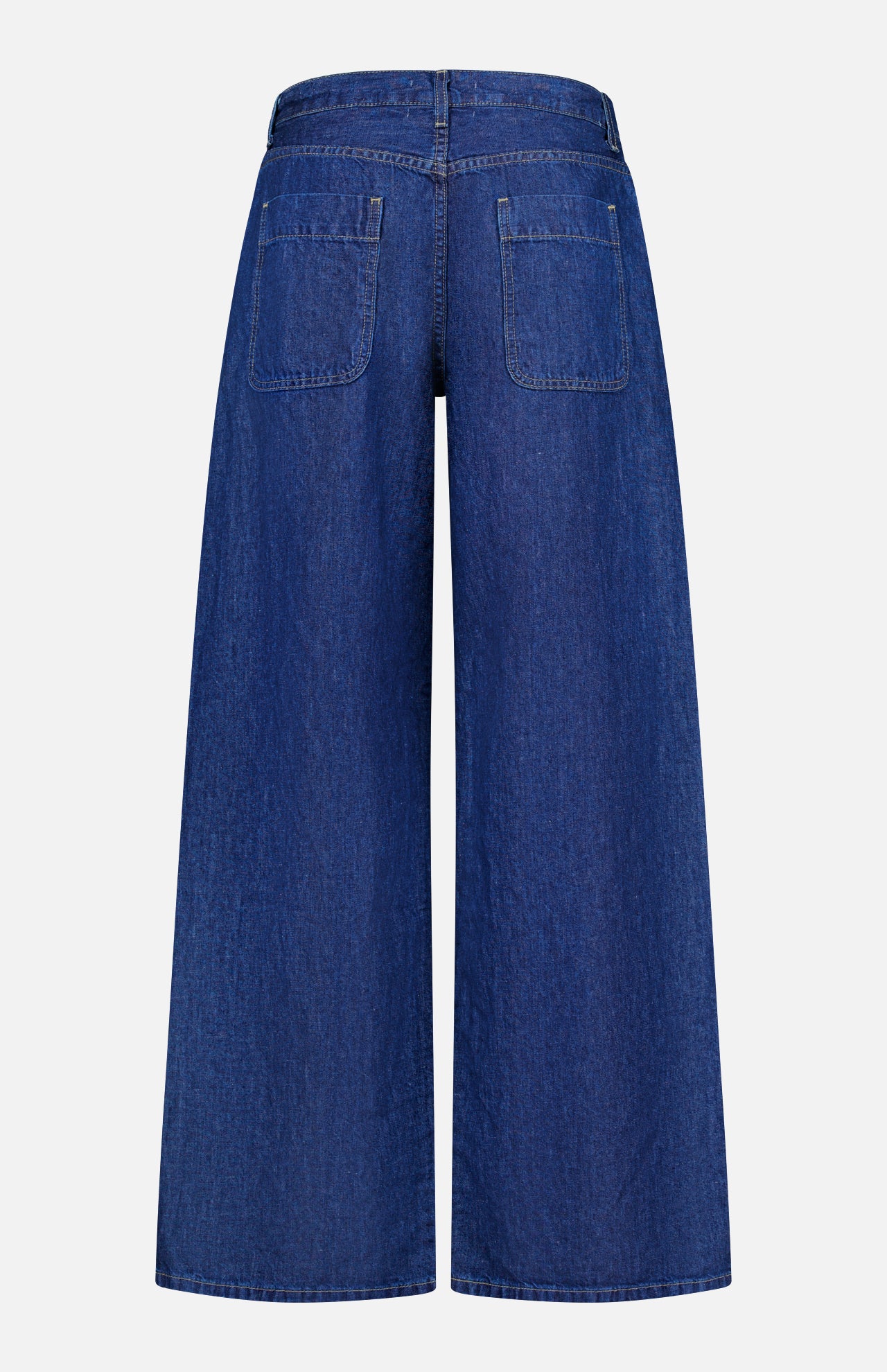 Back view of TWP’s Song Sung Blue Jean in Dark Stone, featuring wide-leg blue denim crafted from a cotton linen blend, with two rear pockets, a high waist, and a loose fit, displayed against a plain white background.