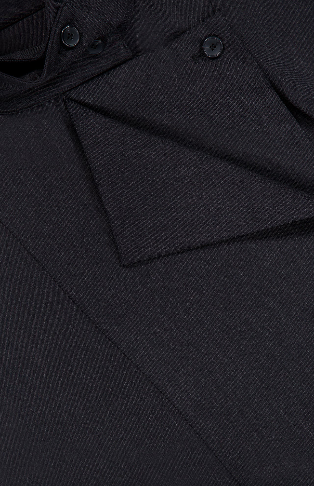 Close-up of The Last Chapter Shirt by TWP, meticulously tailored from dark Italian wool twill, featuring a folded flap and three black buttons—showcasing its rich texture and refined details that elevate classic women’s workwear.