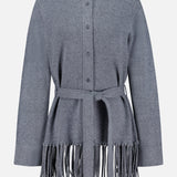 The TWP Thea Fringed Hem Cardigan is a gray button-up style, expertly crafted from luxurious Italian cashmere, featuring a belted waist and long fringe detailing at the hem—an elevated staple for women’s workwear, shown against a white background.