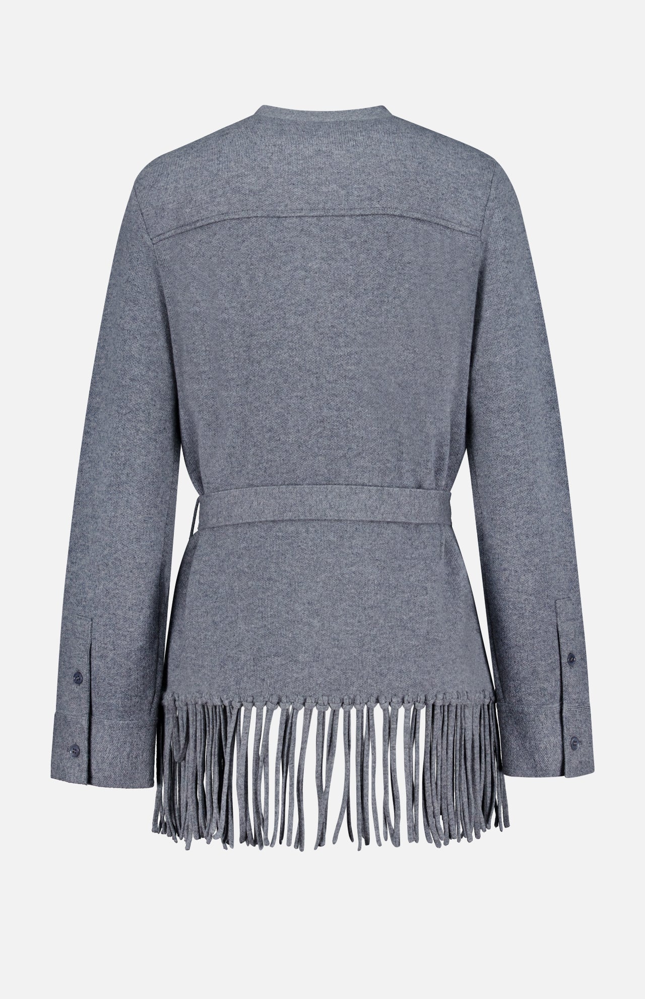 The TWP Thea Fringed Hem Cardigan is a gray long-sleeve cardigan featuring a belted waist and dramatic long fringe along the bottom hem, shown from the back against a plain white background. Button details at the cuffs add an elegant touch, making it an ideal addition to any women’s workwear wardrobe. Inspired by classic Italian cashmere styling, this design offers a modern update to the traditional grey cashmere cardigan.