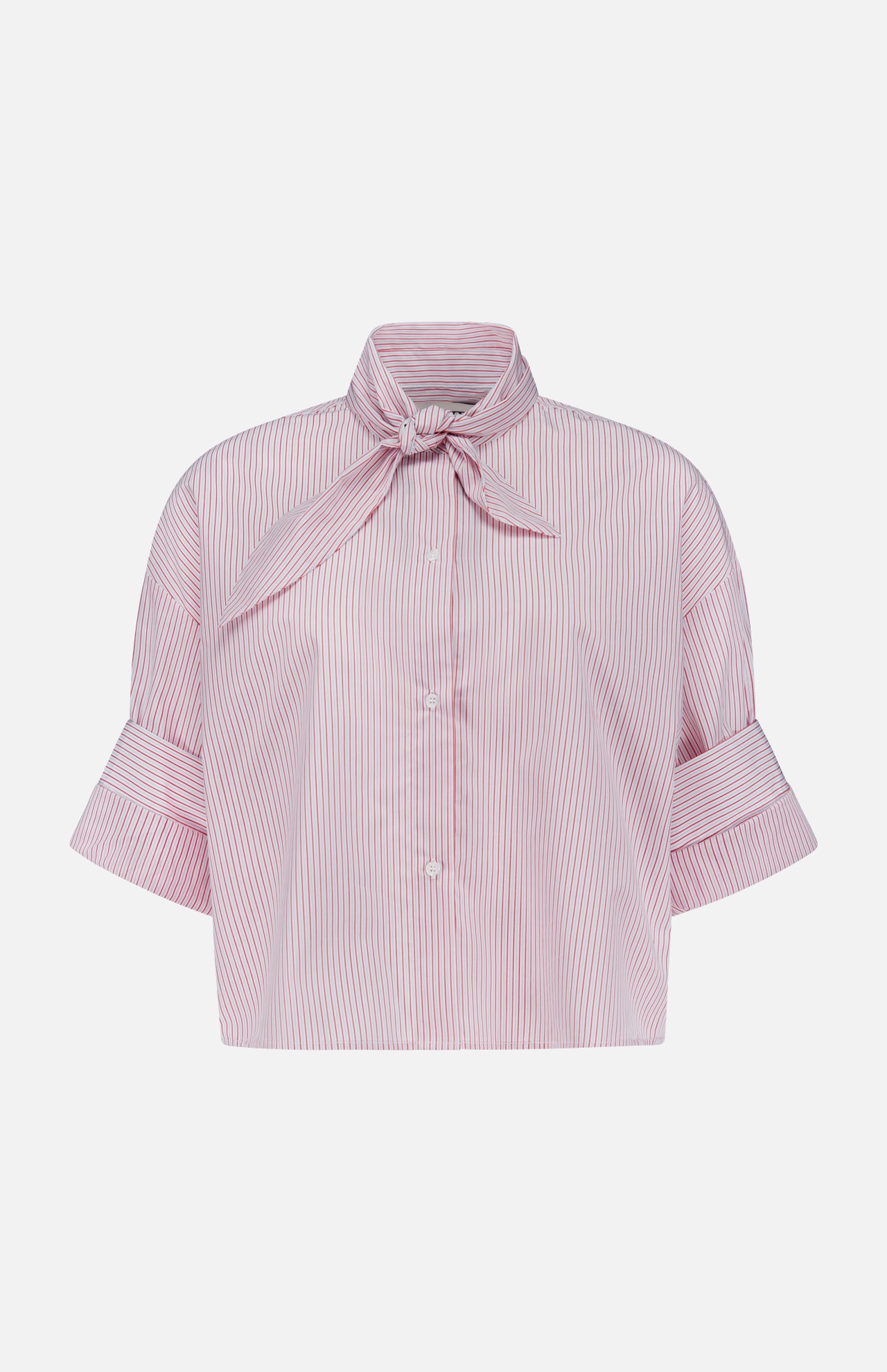 The TWP Tie One On Striped Shirt features red and white vertical stripes, short sleeves with wide cuffs, a bow tie collar, and front buttons—ideal for nautical looks or chic women’s workwear.