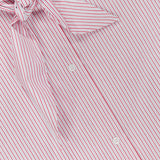 Close-up of the TWP Tie One On Striped Shirt, featuring pink and white vertical stripes, a matching tie at the collar, and two visible white buttons—an ideal workwear piece for women. The shirt label shows the TWP brand.