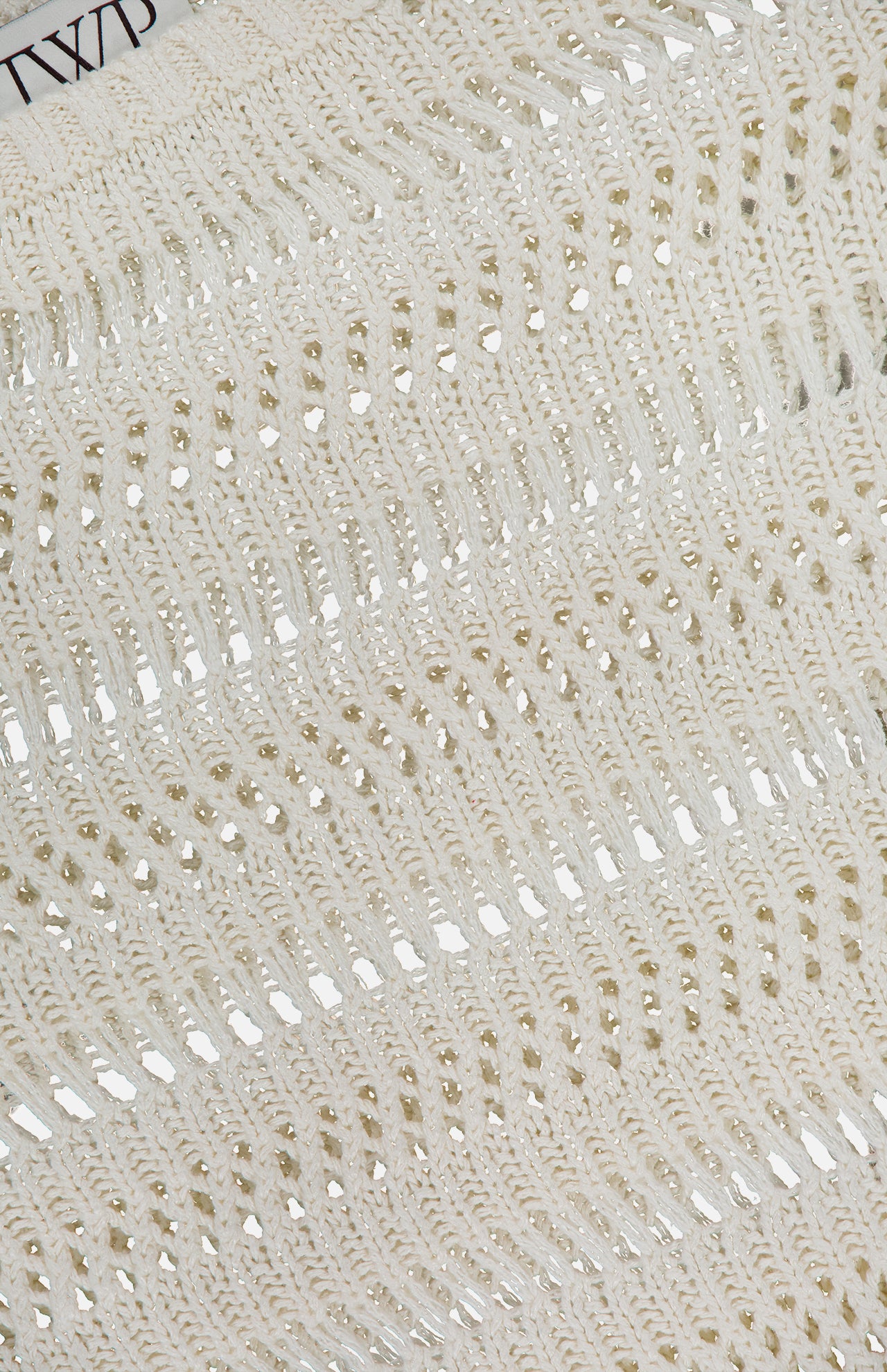 Close-up of the TWP Wide Neck Long Sleeve Knit Sweater in an ivory linen-silk blend, featuring open-knit texture with horizontal holes and loops—ideal for women’s workwear blending comfort and style.