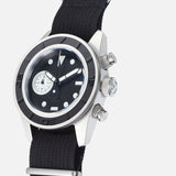 The UNIMATIC U3-AE Unimatic Watch, featuring a Swiss automatic movement and a stainless steel case, showcases a black dial with white markers, a sub-dial, and is paired with a black nylon strap; it is displayed angled upward against a white background.