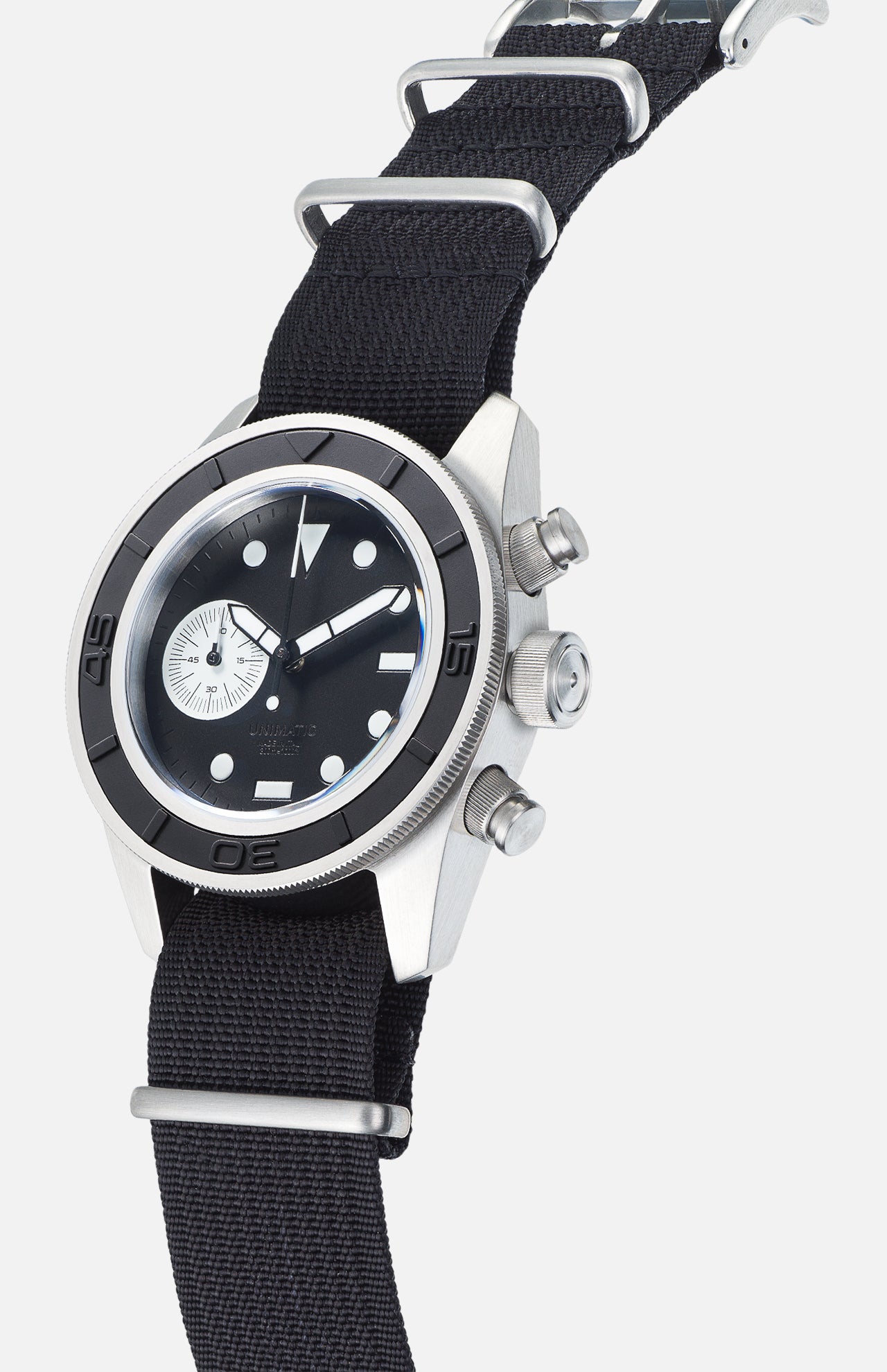 The UNIMATIC U3-AE Unimatic Watch, featuring a Swiss automatic movement and a stainless steel case, showcases a black dial with white markers, a sub-dial, and is paired with a black nylon strap; it is displayed angled upward against a white background.