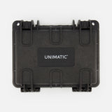 A black protective case with sturdy latches and a white UNIMATIC logo on the center label, photographed against a plain white background—ideal for securely storing your Unimatic Watch Kit U1S-PD6-RB diving watch with Swiss automatic movement.