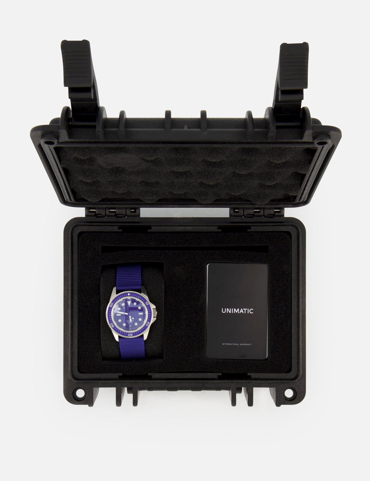 The UNIMATIC Watch Kit U1S-PD6-RB features a blue Unimatic diving watch and a black card, both housed in a black foam-padded protective case with an open lid, proudly displaying its precise Swiss automatic movement.