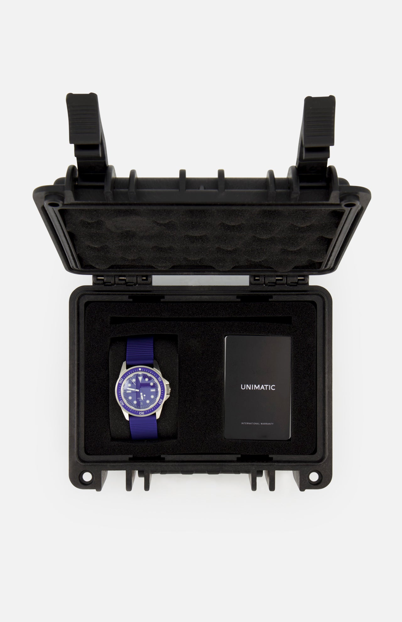 The UNIMATIC Watch Kit U1S-PD6-RB features a blue Unimatic diving watch and a black card, both housed in a black foam-padded protective case with an open lid, proudly displaying its precise Swiss automatic movement.