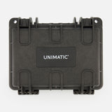 The Unimatic Watch Kit U3FB-ROPS by UNIMATIC is a black, rectangular hard-shell protective case with "UNIMATIC" printed in white on the center of the front panel. Designed to complement your Italian diving watch, this case features sturdy latches and reinforced corners for enhanced durability.