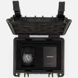 A UNIMATIC Watch Kit U3FB-ROPS, featuring a black Italian diving watch and an instruction manual, is neatly arranged inside an open black protective foam case.