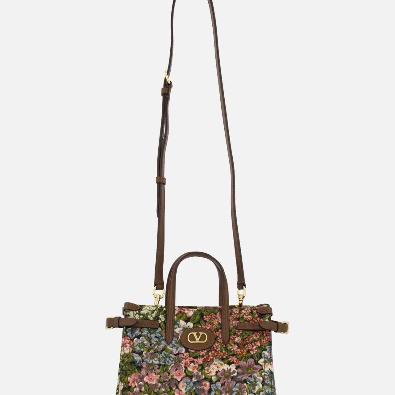The VALENTINO GARAVANI Antibes Small Floral Tote Bag is a jacquard handbag with two handles, a long adjustable shoulder strap, a colorful floral pattern, and gold VLogo hardware on the front.