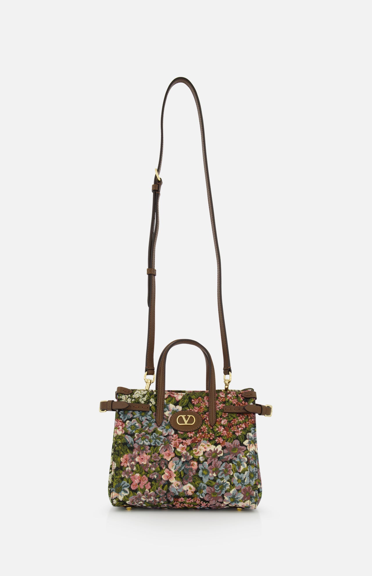 The VALENTINO GARAVANI Antibes Small Floral Tote Bag is a jacquard handbag with two handles, a long adjustable shoulder strap, a colorful floral pattern, and gold VLogo hardware on the front.