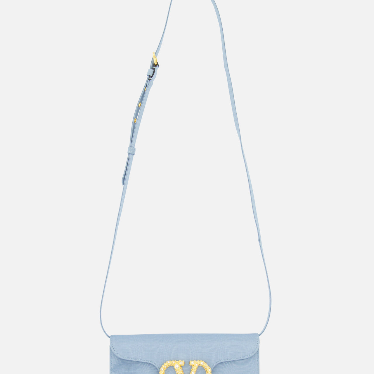 A light blue VALENTINO GARAVANI Loco Swarovski Crystal Clutch with an adjustable strap and a prominent gold VLogo Signature clasp on the front flap, displayed against a plain white background.