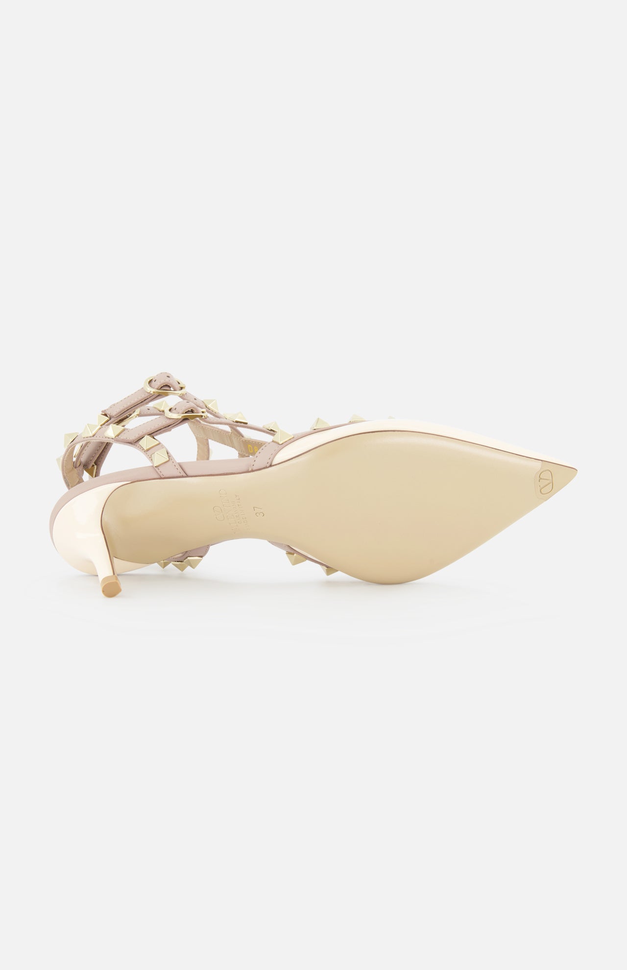 The Rockstud Ankle Strap Heel T.65 by VALENTINO GARAVANI, a beige patent leather pump with gold rockstuds and multiple ankle straps, is shown on its side revealing the sole and pointed toe against a plain white background.