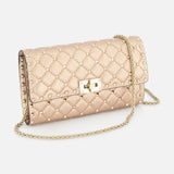 The VALENTINO GARAVANI Rockstud Spike Shoulder Bag is a quilted metallic gold clutch with gold studs, a removable chain strap, and a rectangular gold clasp, shown against a white background.