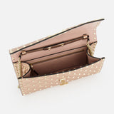 A top-down view of the VALENTINO GARAVANI Rockstud Spike Shoulder Bag in beige quilted leather with gold-tone studs displays its spacious interior, zippered pocket, and multiple compartments on a white background.