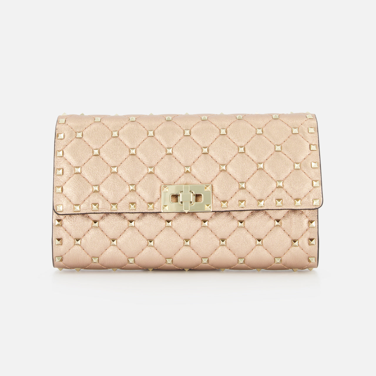 The VALENTINO GARAVANI Rockstud Spike Shoulder Bag is a beige, quilted leather bag with gold-tone studs, a rectangular metal clasp, and a removable chain strap, shown against a plain white background.