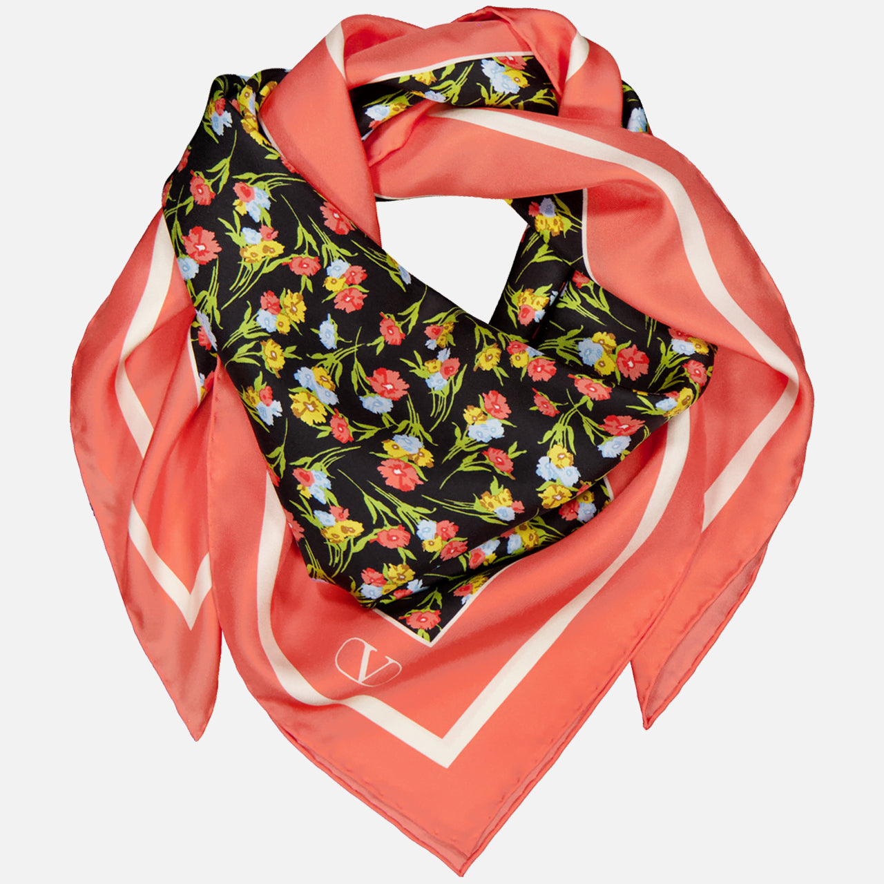 The VALENTINO GARAVANI Shawls Fouland Silk Scarf is a square Italian-made silk scarf with a coral pink border, black center, and colorful floral print in red, yellow, and green, styled in a loose, layered fold.