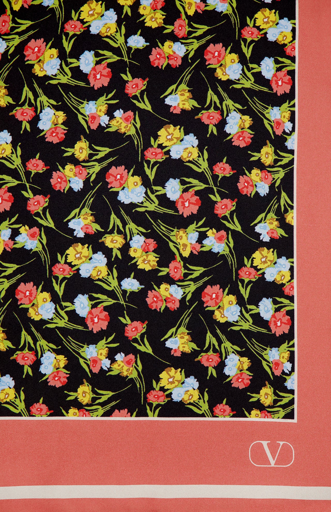 The Shawls Foulard Silk Scarf by VALENTINO GARAVANI features a black background with small red, yellow, and blue flowers, green stems, wide coral-pink borders, and a white V logo in the corner. Made in Italy.