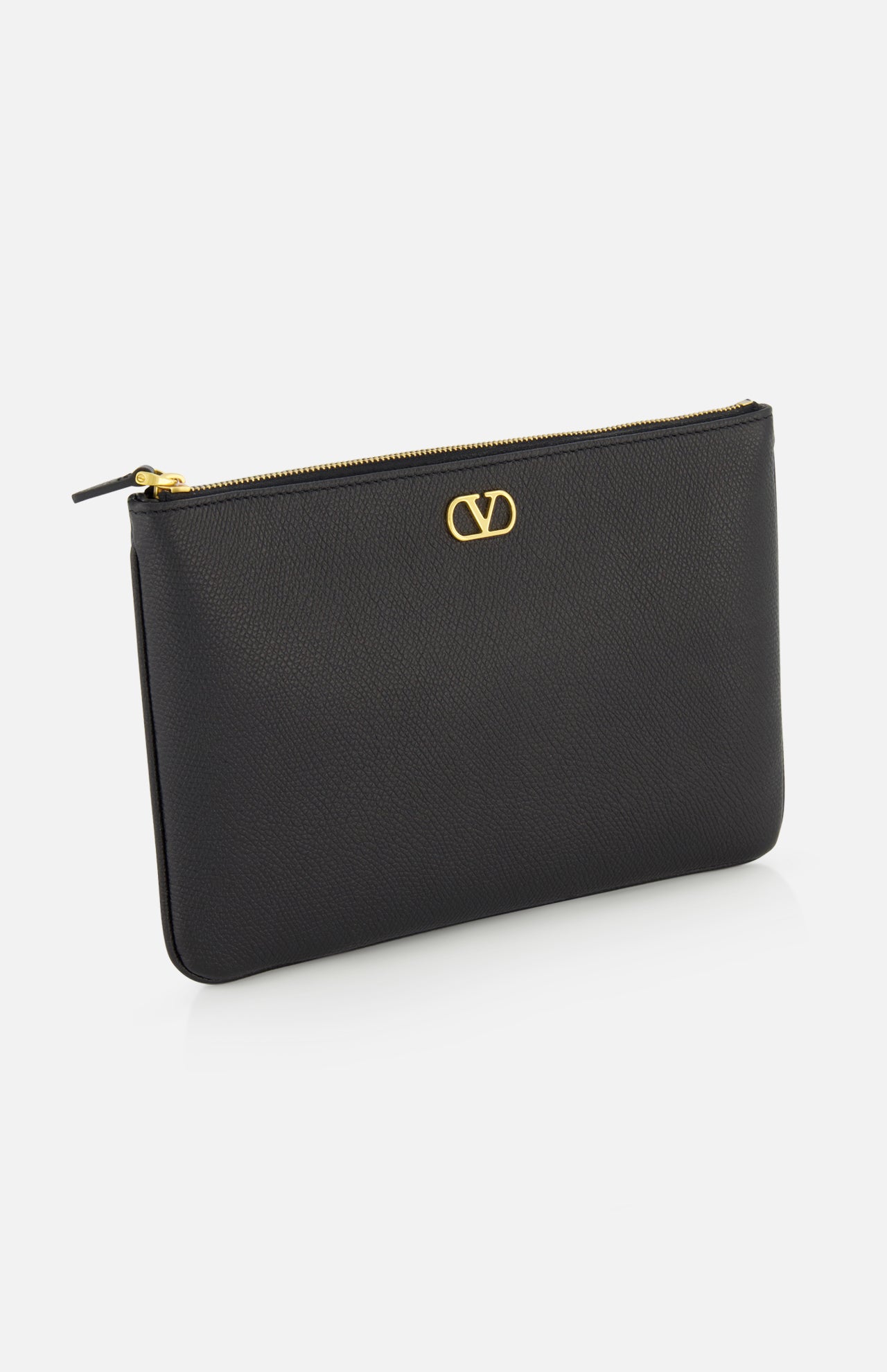 The V Logo Signature Medium Flat Pouch by VALENTINO GARAVANI is a black leather clutch with a gold zipper and small gold logo on the front, shown against a white background.