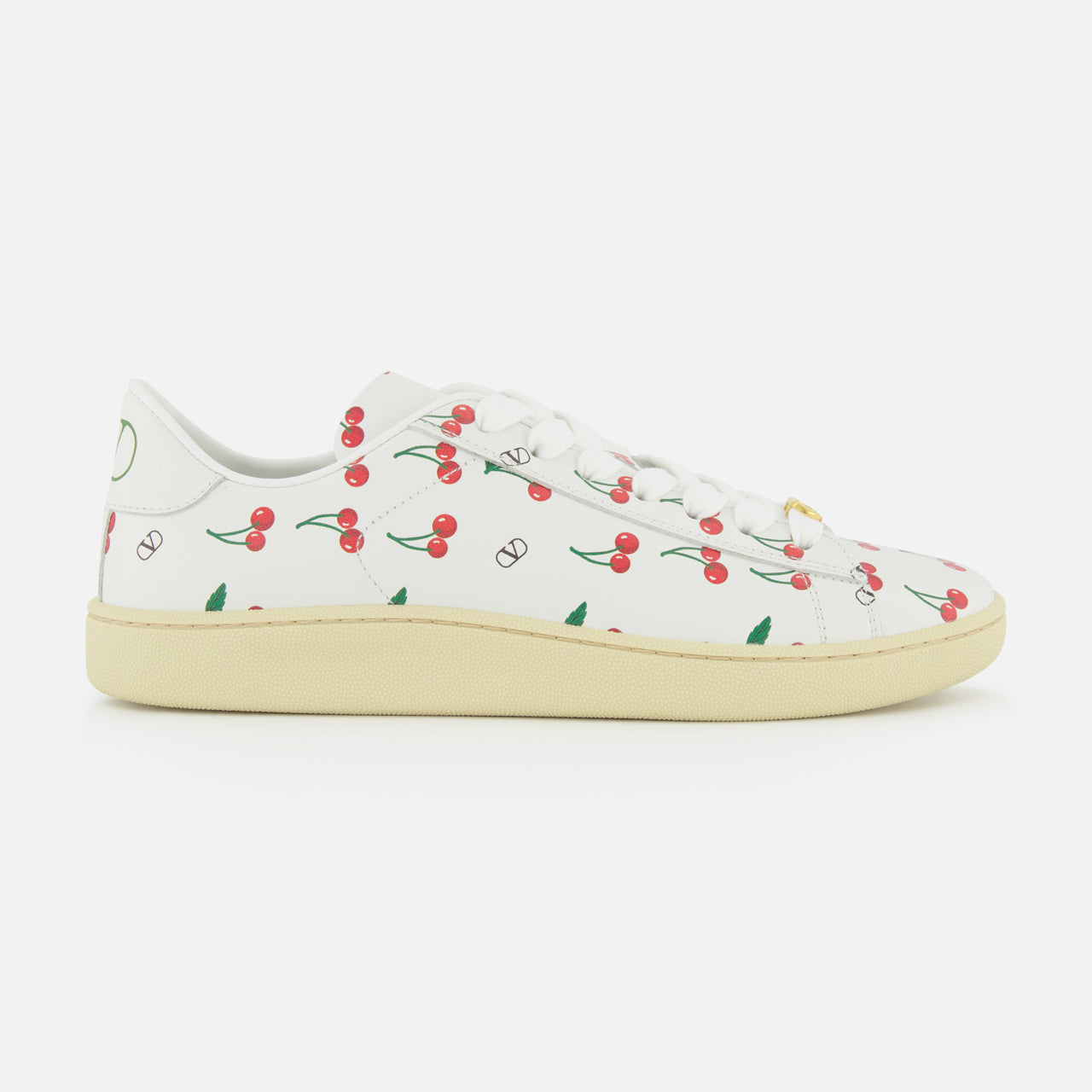 The Valentino Garavani Royco Sneaker by VALENTINO GARAVANI features white leather, a beige sole, and playful red cherry and green leaf motifs for a fresh designer look.