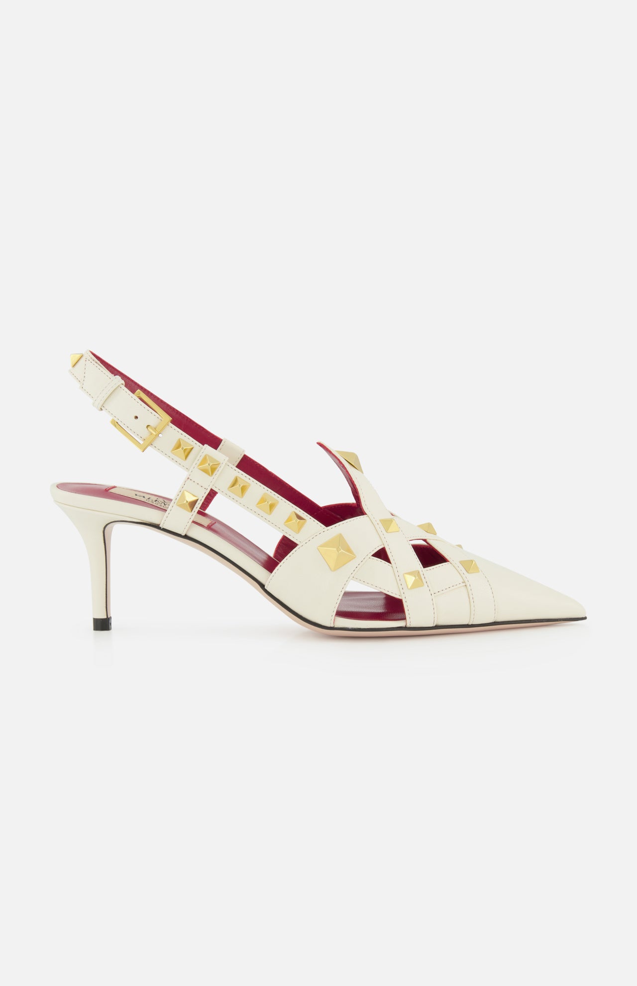 The Valentino Garavani Studdy Sling Back Heel T.65 features ivory leather, pointed toe, gold square studs, strappy ankle strap design, mid-height stiletto heel, and pink-red inner lining against a white background.