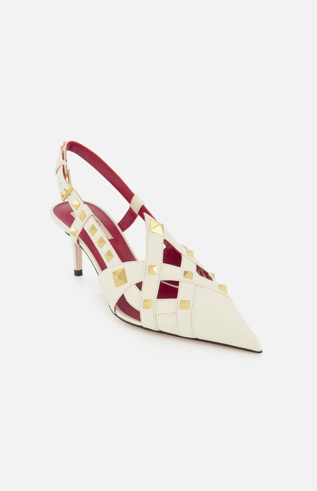 The Valentino Garavani Studdy Sling Back Heel T.65 features ivory leather, a pointed toe, gold pyramid studs, ankle strap, strappy design, and a red insole by VALENTINO GARAVANI, shown on a white background.