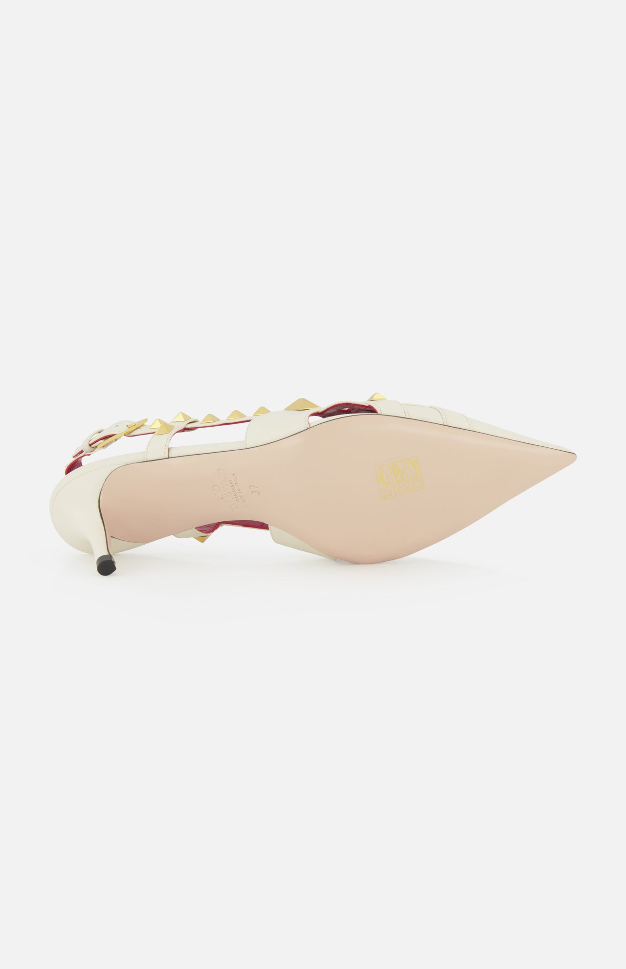The VALENTINO GARAVANI Studdy Sling Back Heel T.65 features a white pointed toe, gold pyramid studs, pink trim, an elegant ankle strap, and smooth sole—showcasing the brand’s signature design details.