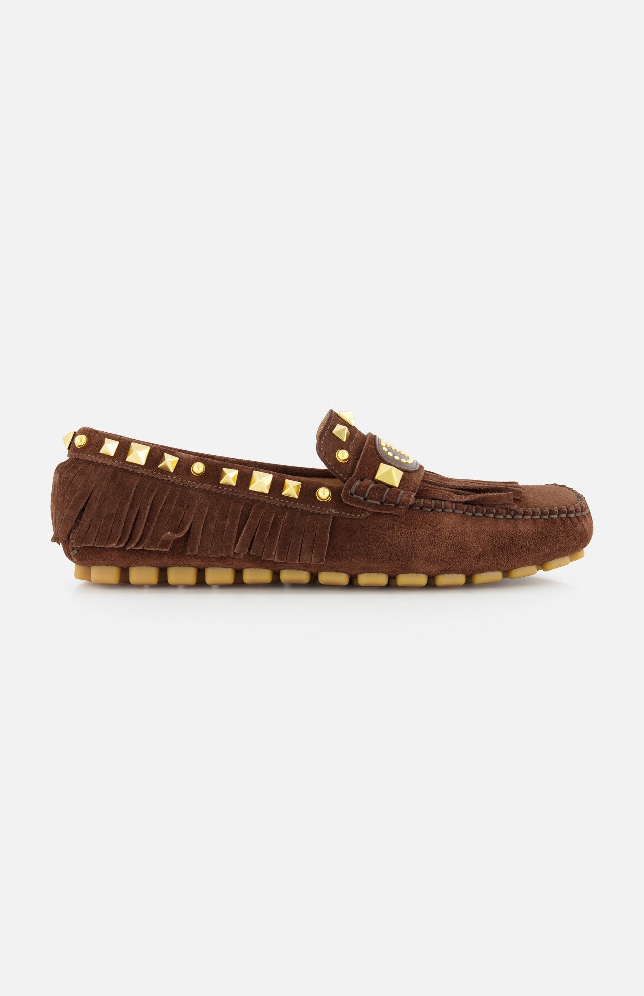 The VALENTINO GARAVANI VG Plaster Caster Driver Loafer T.05, a handcrafted brown suede moccasin with gold studs, fringe trim, and a rubber sole, is shown in side profile against a plain white background.