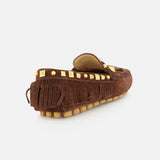 The VALENTINO GARAVANI VG Plaster Caster Driver Loafer T.05 is a brown suede bohemian loafer with handcrafted fringe trim, gold square studs on the heel collar, and a tan rubber sole with raised treads, shown angled from the back on white.