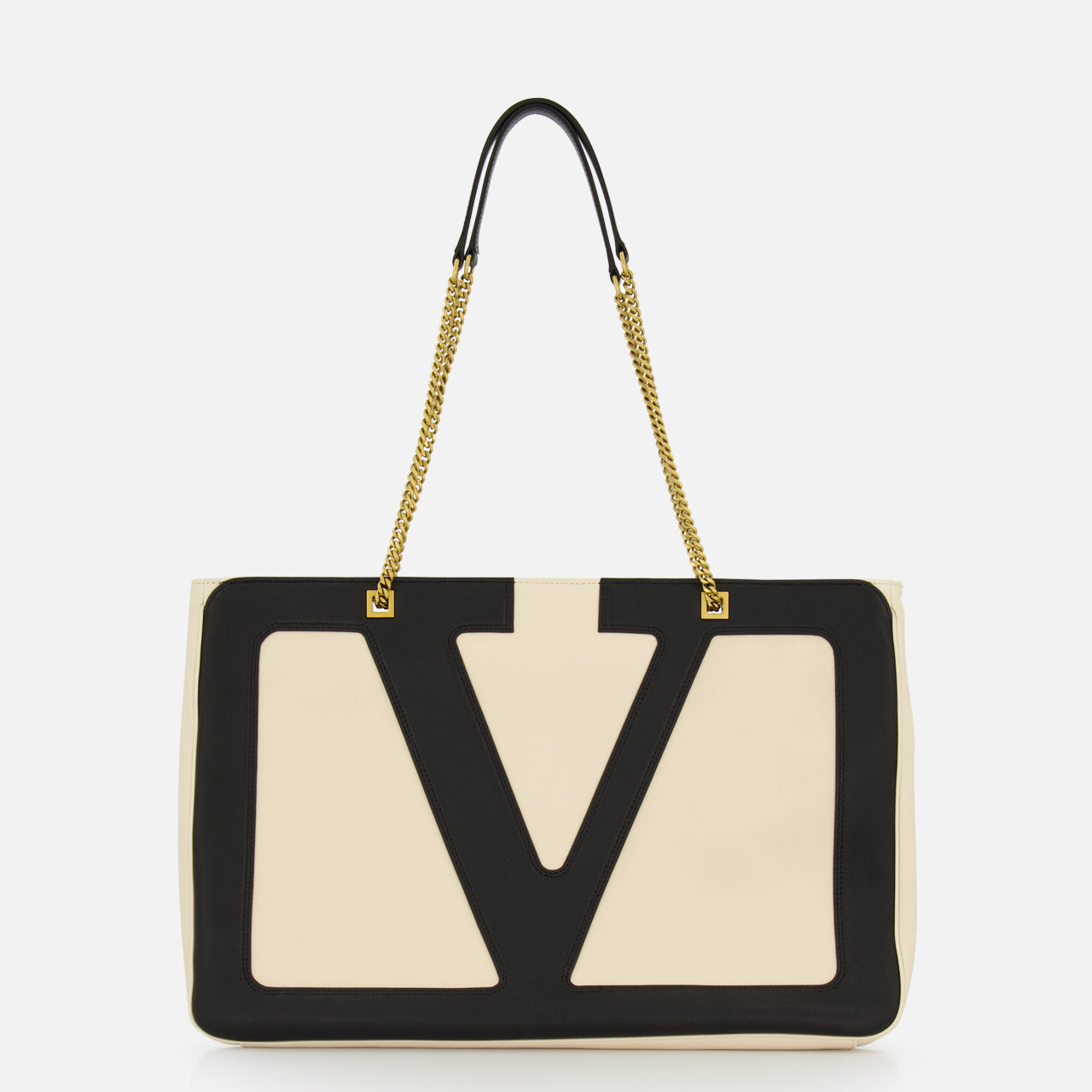 The VALENTINO GARAVANI Viva Superstar Large Tote Bag showcases beige leather with bold black V-shaped trim and gold chain handles on black straps, making this chic accessory stand out against a plain white background.