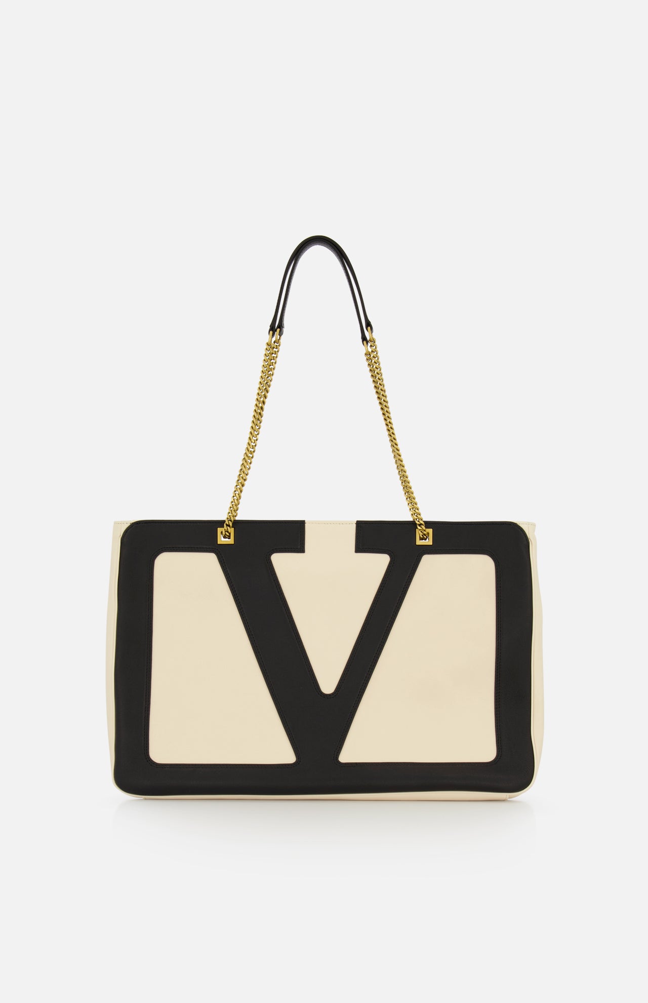 The VALENTINO GARAVANI Viva Superstar Large Tote Bag showcases beige leather with bold black V-shaped trim and gold chain handles on black straps, making this chic accessory stand out against a plain white background.