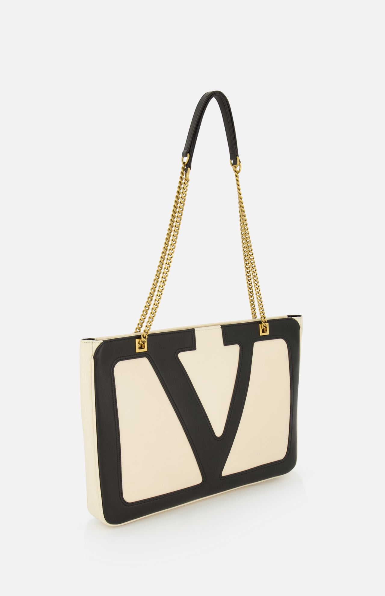 The VALENTINO GARAVANI Viva Superstar Medium Tote Bag features a rectangular cream leather design with a bold black VLogo on the front, gold chain straps, and black leather shoulder detail, shown against a white background.