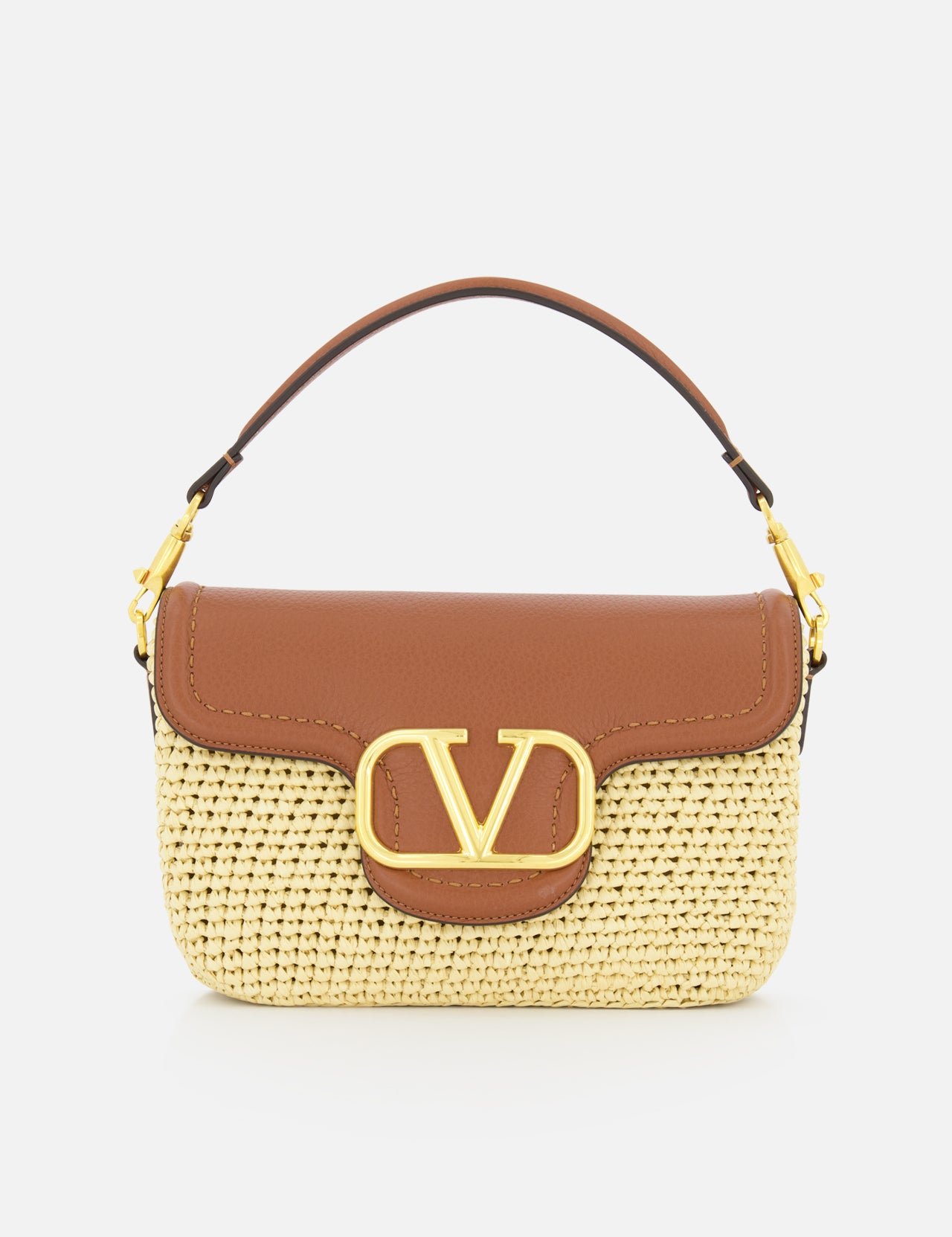 The VALENTINO GARAVANI Alltime Cherry Strap Shoulder Bag features a woven straw base, brown leather flap and handle, gold hardware, and a bold gold “V” logo on the front for stylish elegance.
