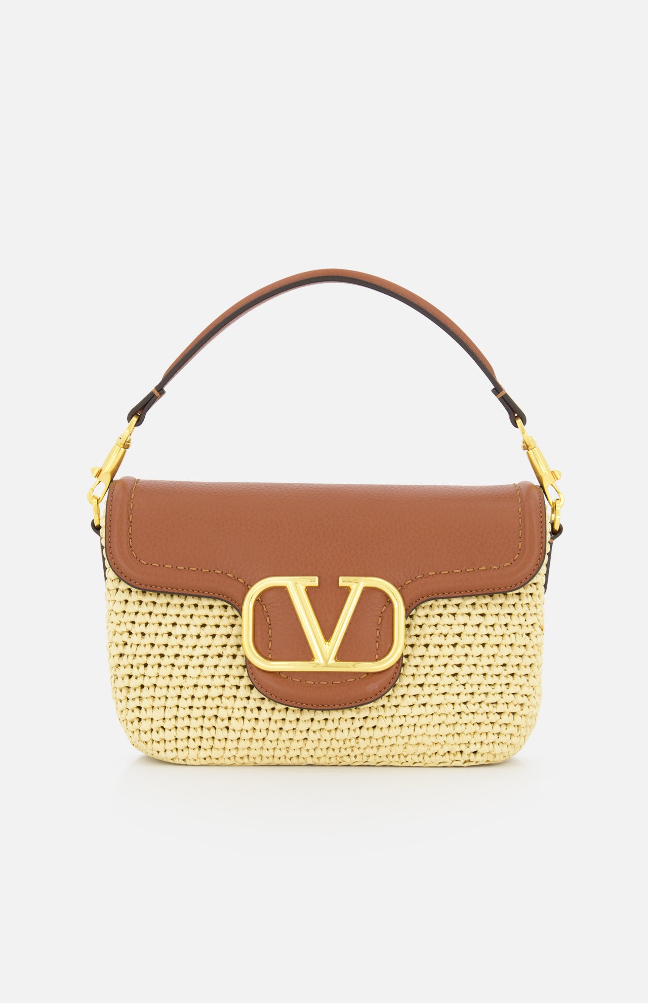 The VALENTINO GARAVANI Alltime Cherry Strap Shoulder Bag features a woven straw base, brown leather flap and handle, gold hardware, and a bold gold “V” logo on the front for stylish elegance.