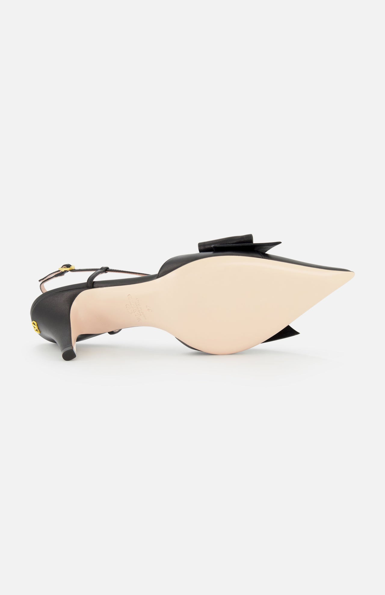 The VALENTINO GARAVANI Bowow Sling Back Heel, a black leather pointed-toe pump with an adjustable ankle strap and decorative bow, is shown on its side, highlighting its smooth, light-colored sole.