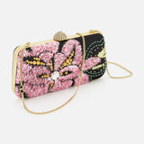The VALENTINO GARAVANI Carry Secrets Miniaudiere Bag features a gold chain strap, jeweled clasp, and is adorned with pink, yellow, and green sequined floral patterns.