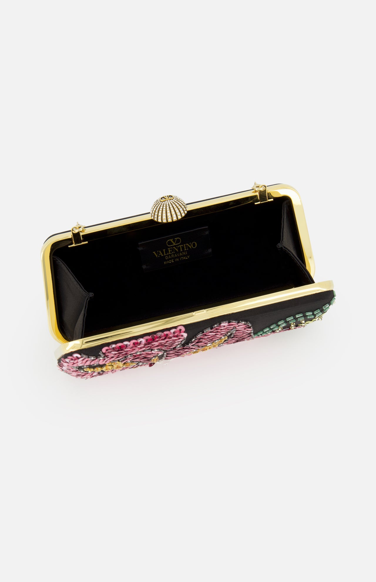 The Carry Secrets Minaudière Bag by Valentino Garavani is a black evening bag with an open gold frame, black interior, and Valentino label. The exterior shines with colorful beaded floral designs for a stunning effect.