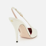 The VALENTINO GARAVANI Cuttie Sling Back Heel, in ivory leather with a pointed toe, gold buckle, gold logo on the heel, and light pink insole, is shown against a plain white background.
