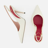 The VALENTINO GARAVANI Cuttie Sling Back Heel features elegant ivory leather, pointed toes, red insoles, and a chic ankle strap—shown on a white background.