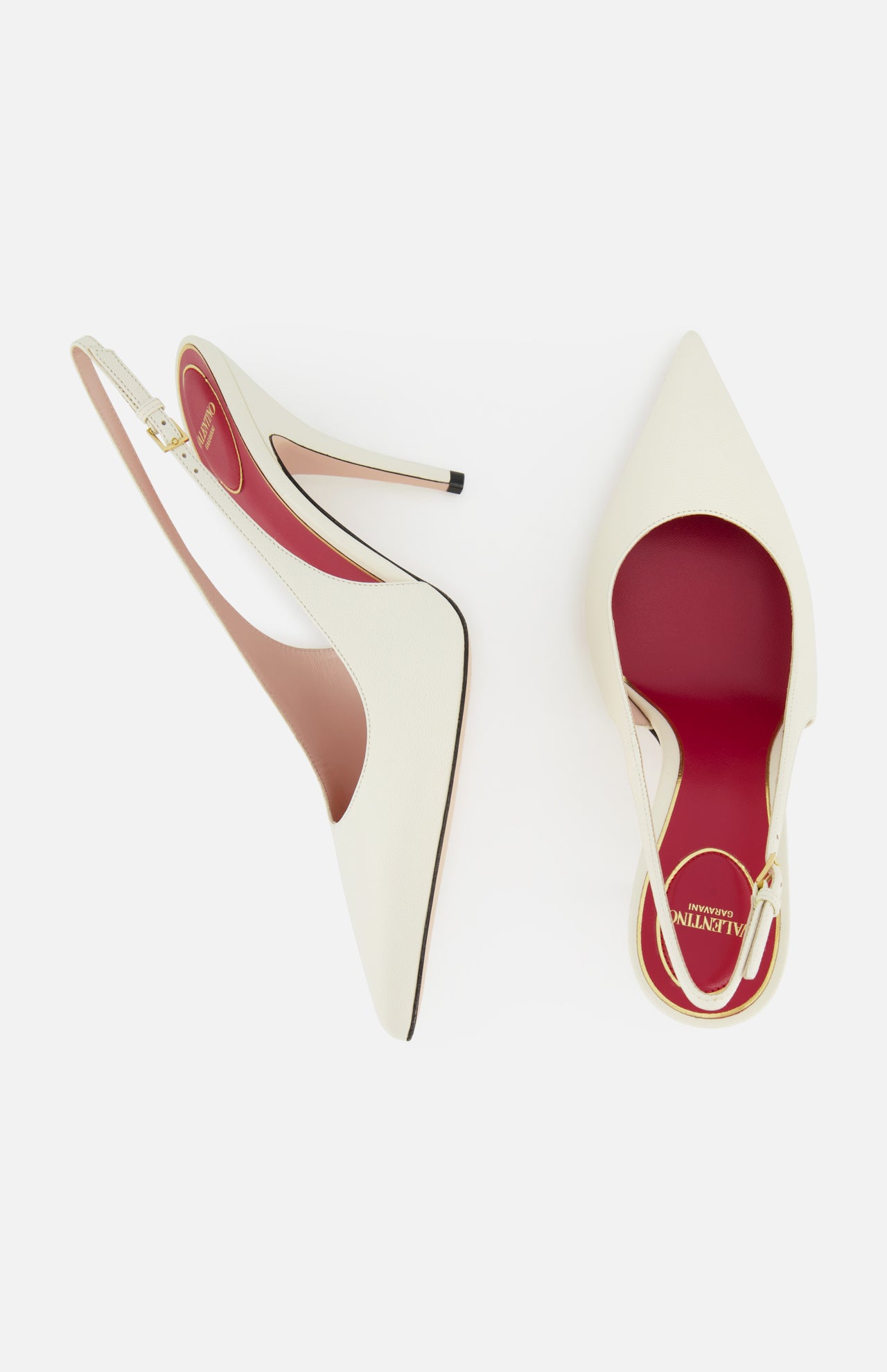 The VALENTINO GARAVANI Cuttie Sling Back Heel features elegant ivory leather, pointed toes, red insoles, and a chic ankle strap—shown on a white background.