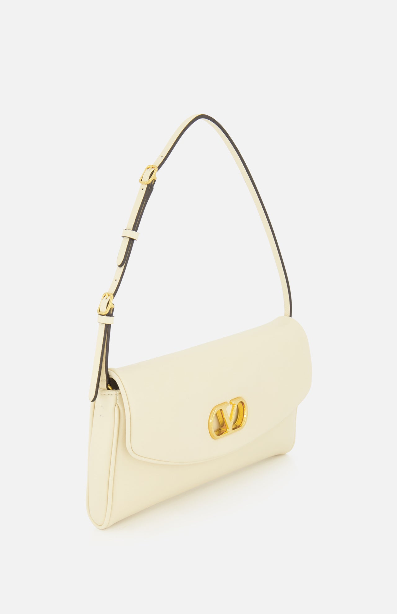 The Devain Small Shoulder Bag by VALENTINO GARAVANI is crafted from cream-colored lambskin leather and features an adjustable strap, gold VLOGO hardware, and a decorative logo clasp on the front flap, shown against a plain white background.