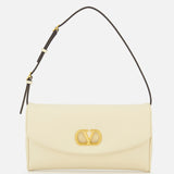 The Devain Small Shoulder Bag by VALENTINO GARAVANI is crafted from cream-colored lambskin leather and showcases gold VLOGO hardware on the front flap, with a short, adjustable dark strap and a minimalist, elegant design.