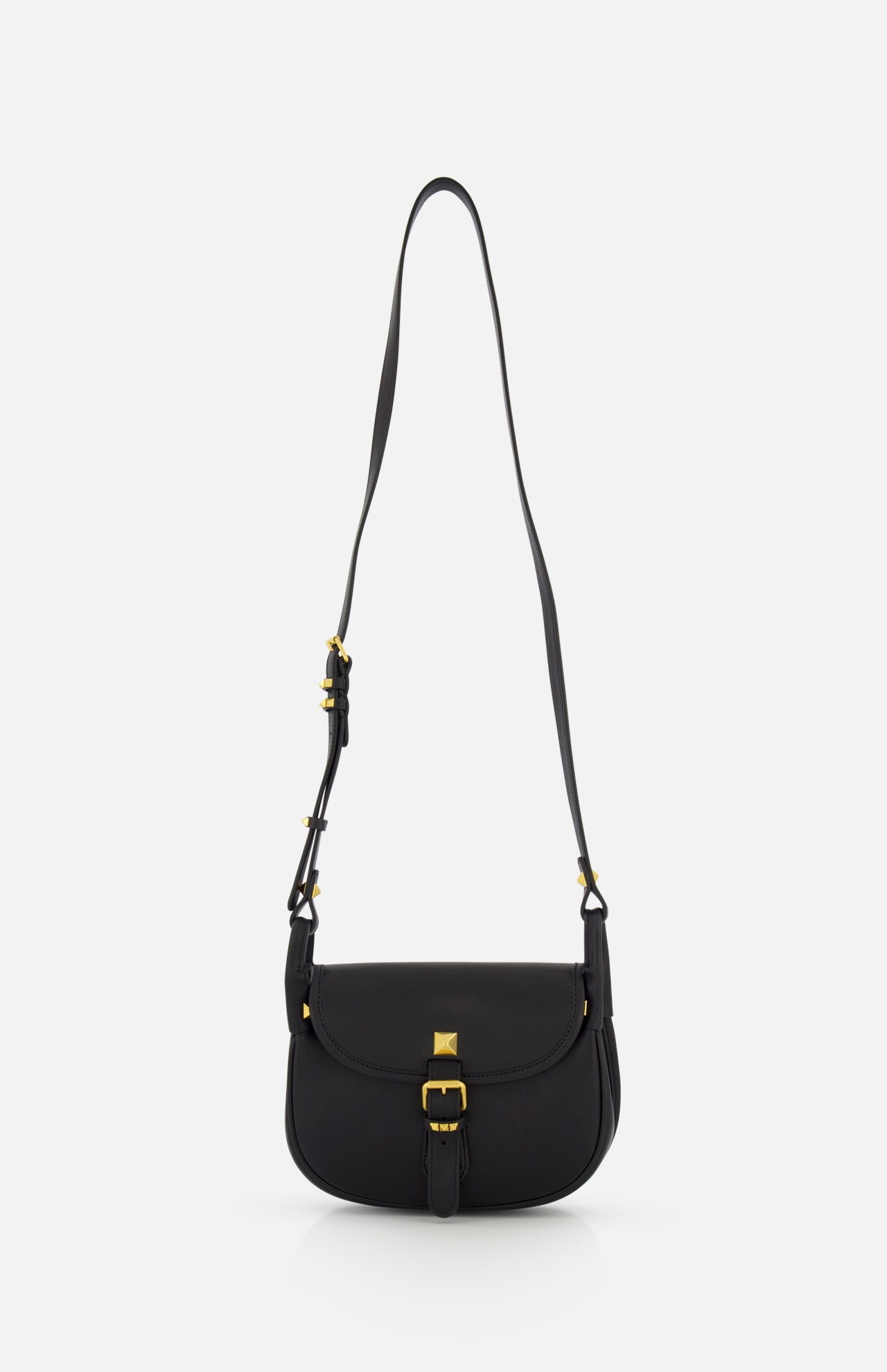 The VALENTINO GARAVANI Flaneuse Small Shoulder Bag in black leather showcases gold hardware, a long adjustable strap, and a front flap with gold buckle detail—an elegant designer accessory for any occasion.