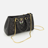 Valentino Garavani Flutterby Quilted Mini Bag in black lambskin featuring a gold logo, small butterfly emblem, and gold chain shoulder strap.