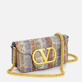 The VALENTINO GARAVANI Loco Small Animal Print Shoulder Bag features a gold chain strap, animal print in purple, gray, and beige tones, and a bold gold V logo on the front flap.